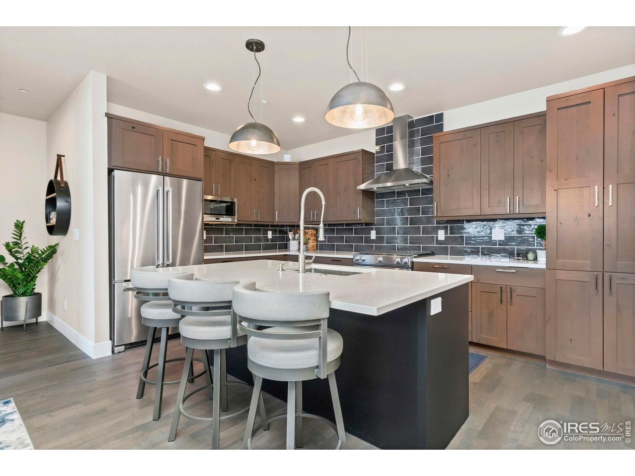 910 Hill Pond Road, Unit 15 Fort Collins, CO 80526 - Photo 17 of 43 a kitchen with kitchen island granite countertop a sink cabinets and stainless steel appliances