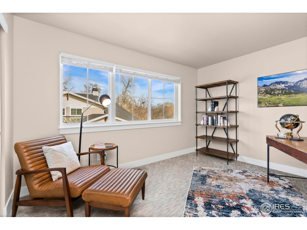 910 Hill Pond Road, Unit 15 Fort Collins, CO 80526 - Photo 23 of 43 a bedroom with furniture and wooden floor