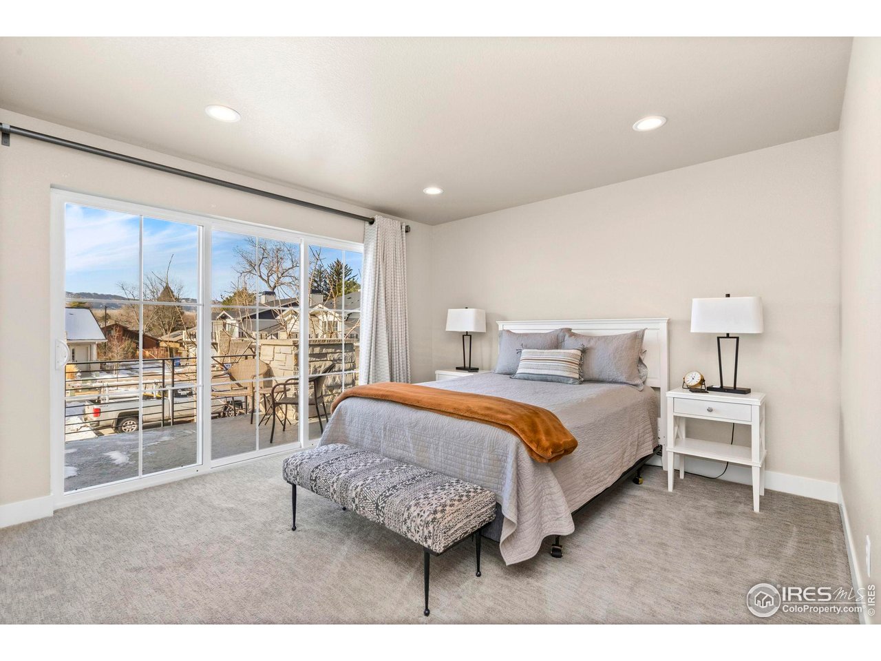 910 Hill Pond Road, Unit 15 Fort Collins, CO 80526 - Photo 30 of 43 a spacious bedroom with a bed and a large window