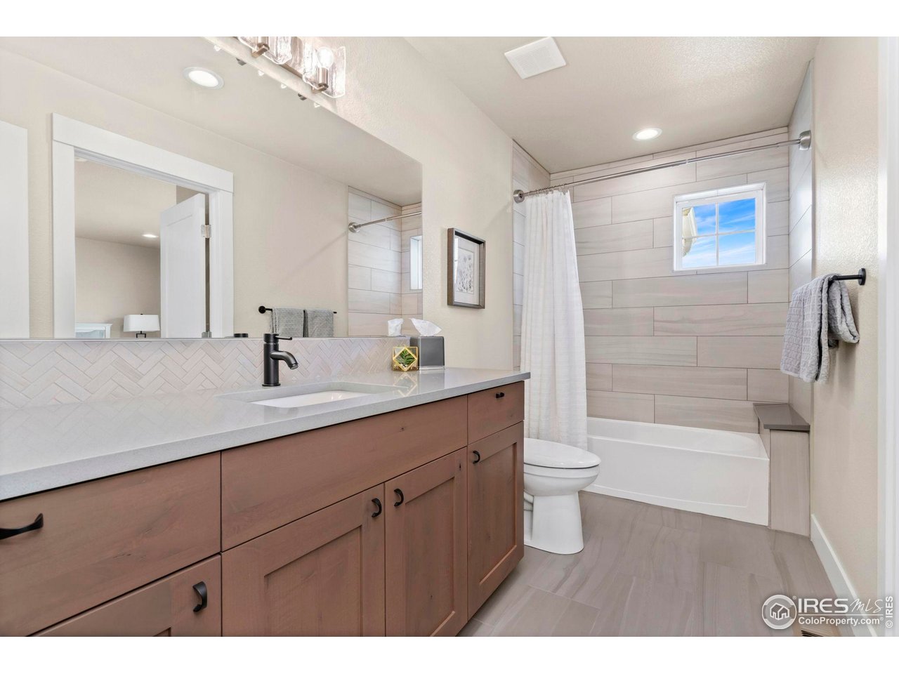 910 Hill Pond Road, Unit 15 Fort Collins, CO 80526 - Photo 32 of 43 a bathroom with a double vanity sink toilet and shower