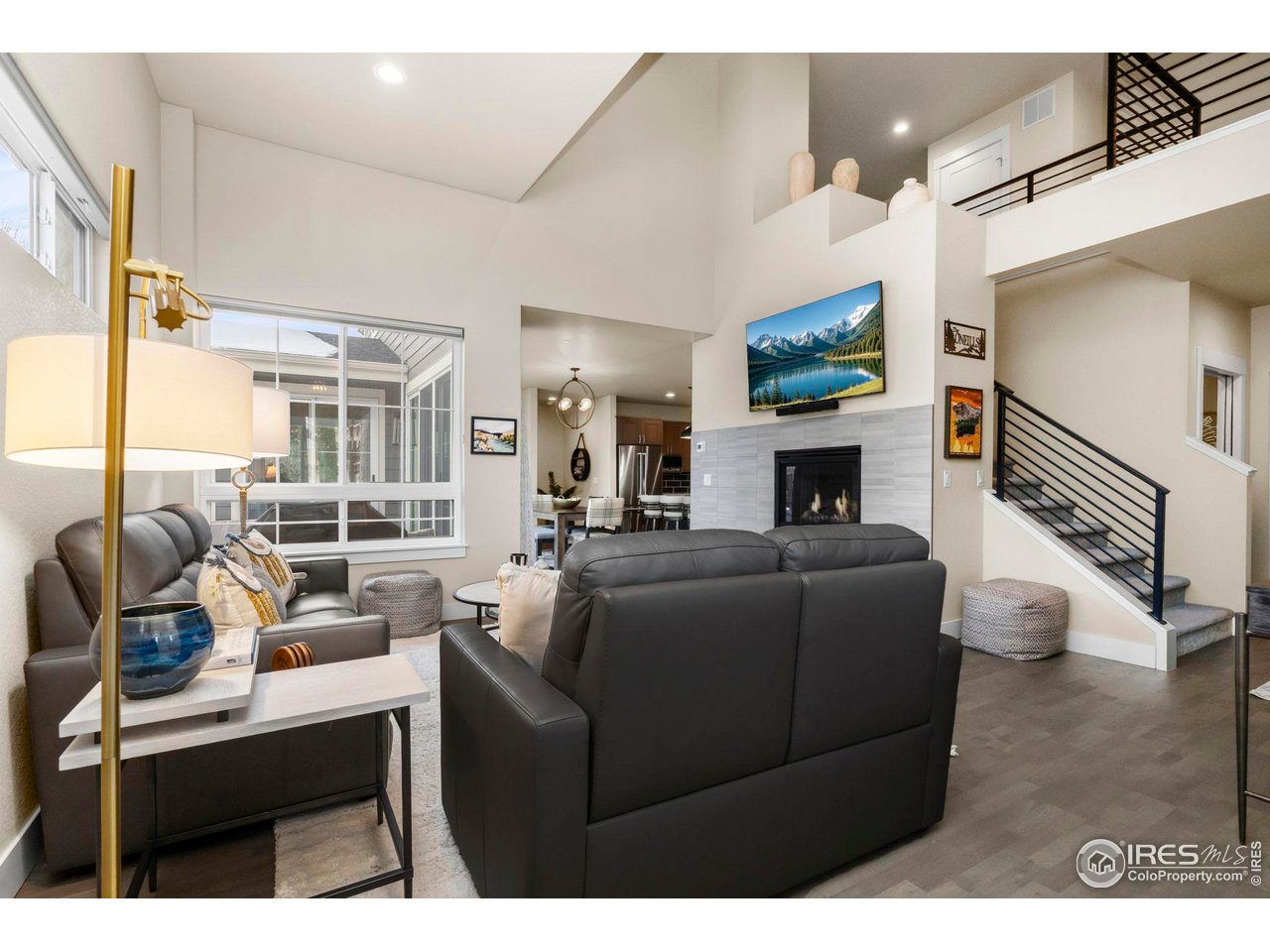 910 Hill Pond Road, Unit 15 Fort Collins, CO 80526 - Photo 5 of 43 a living room with furniture a fireplace and a flat screen tv