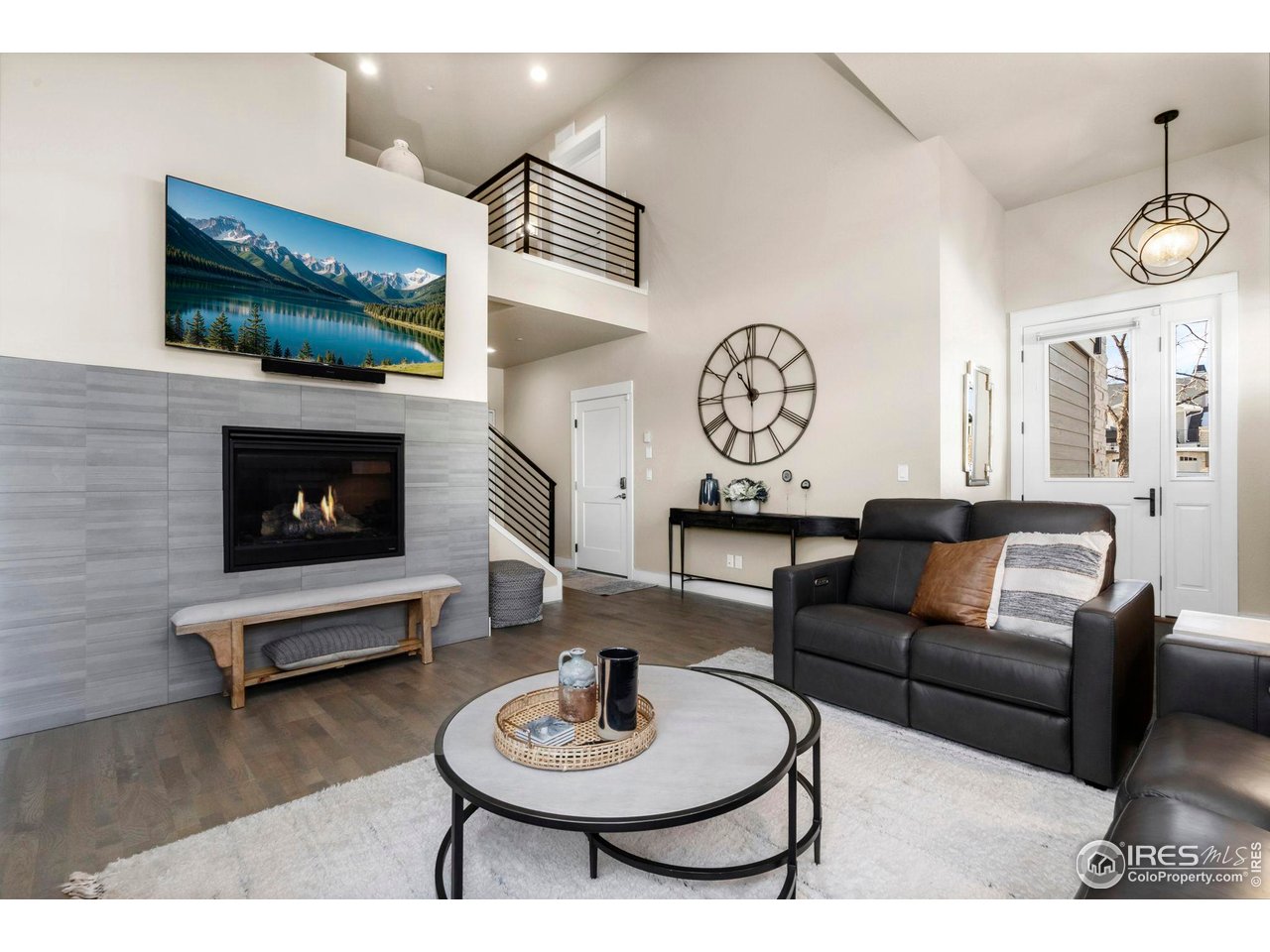 910 Hill Pond Road, Unit 15 Fort Collins, CO 80526 - Photo 9 of 43 a living room with furniture a clock and a fireplace