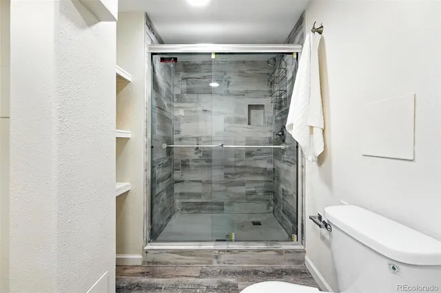 a bathroom with a shower and a toilet