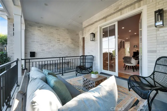 a living room with furniture kitchen and a chandelier