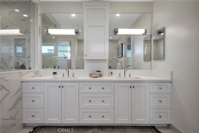 a bathroom with a sink toilet a mirror and shower