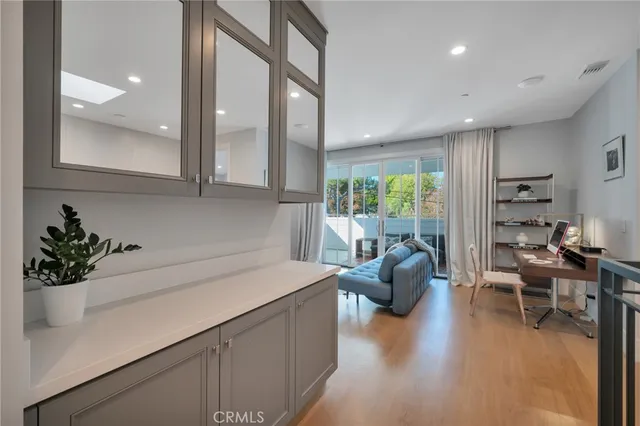 a view of a house with potted plants and a yard