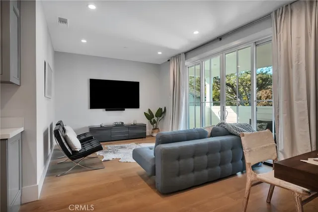 a view of a chair and table in backyard of the house