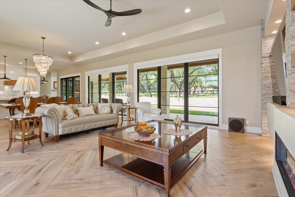 309 Highland Spring Lane Georgetown, TX 78633 - Photo 5 of 40 An incredible wall of Anderson windows/doors display the amazing view of the shaded back yard...