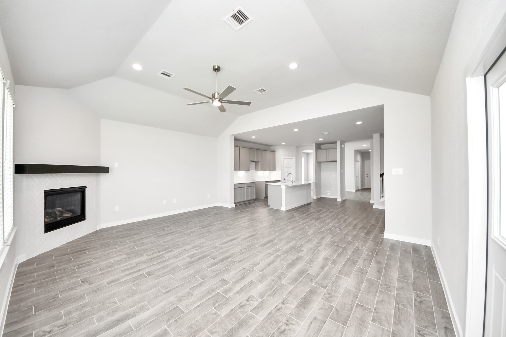 24502 Broad Park Spring, TX 77373 - Photo 24 of 47 Welcome family and guests to your charming living room! With its high ceilings, recessed lighting, ceiling fan, custom paint, beautiful flooring, and large windows that let in abundant natural light, this room is perfect for gatherings.