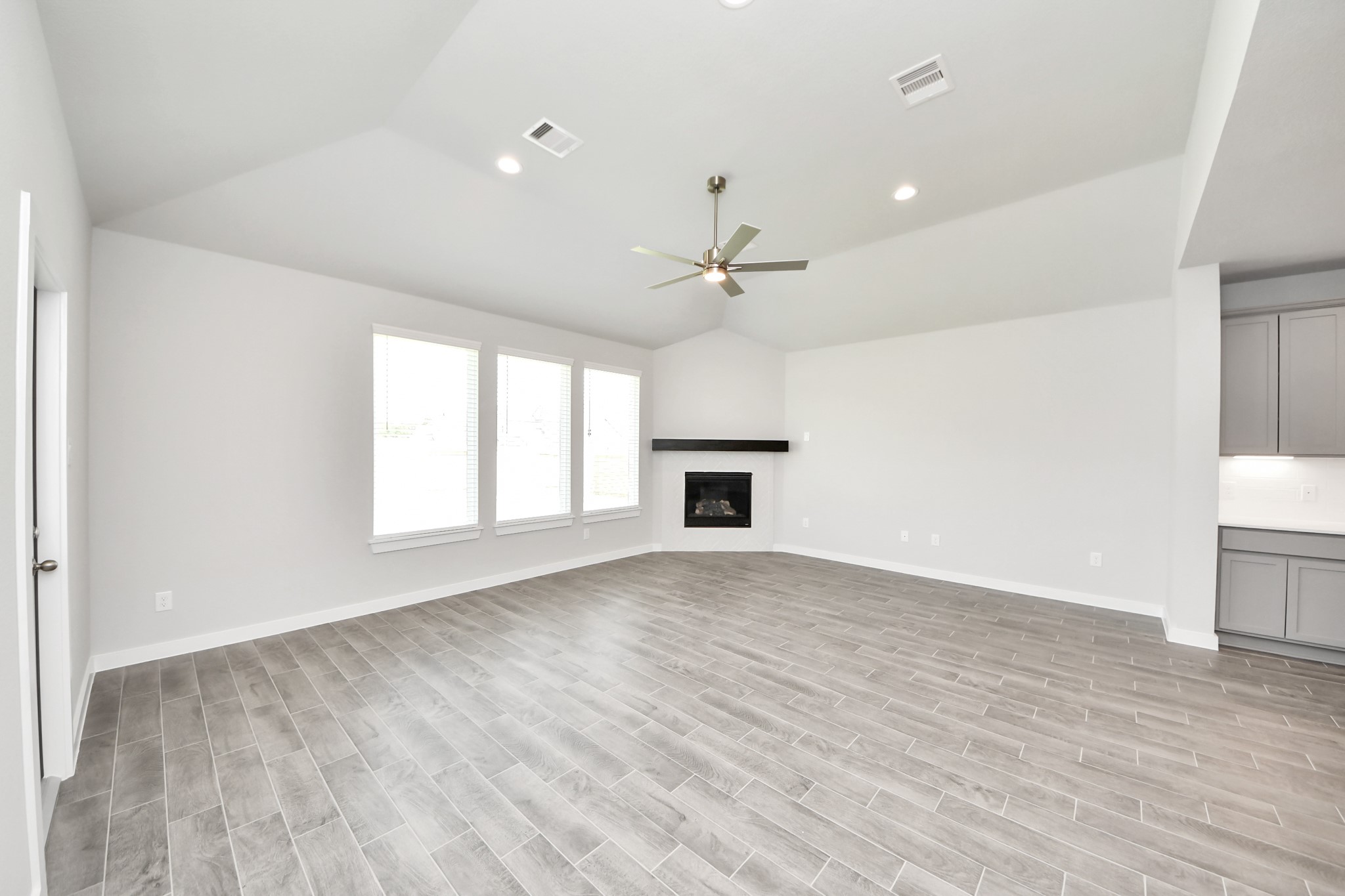 24502 Broad Park Spring, TX 77373 - Photo 25 of 47 Family room flooded with natural light through the expansive windows. The premium tile flooring adds a touch of luxury to the space, creating the perfect setting for relaxing moments and cherished gatherings with loved ones