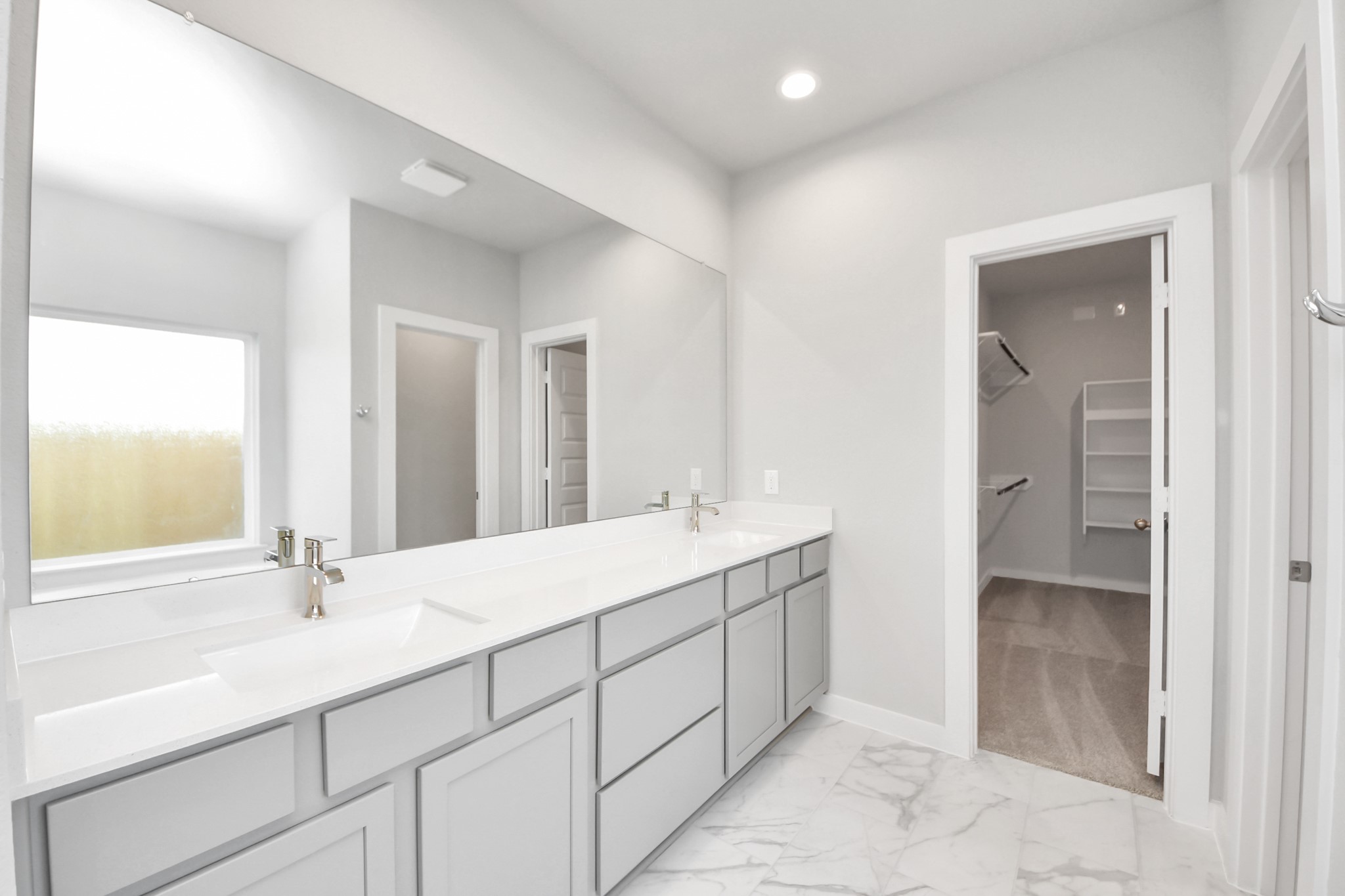 24502 Broad Park Spring, TX 77373 - Photo 30 of 47 Elevate your daily routine at the elegant vanity, now equipped with double sinks, light countertops, modern hardware, and beautiful recessed lights.