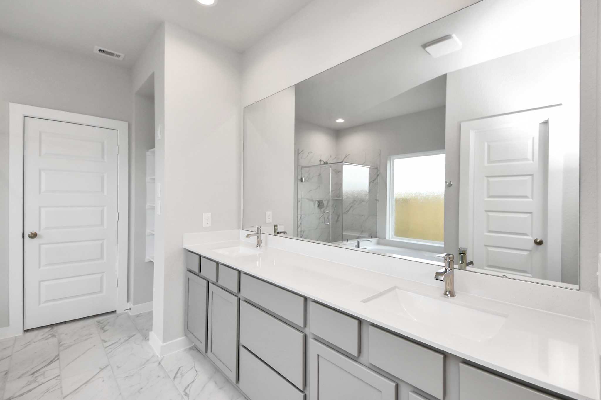 24502 Broad Park Spring, TX 77373 - Photo 32 of 47 Elevate your daily routine at the refined vanity, now boasting double sinks, light-toned countertops, modern hardware, and captivating recessed lights.