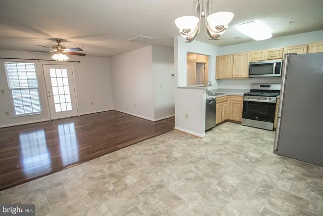 a view of a kitchen with a stove cabinets and wooden floor