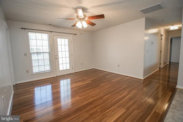wooden floor in an empty room with a window