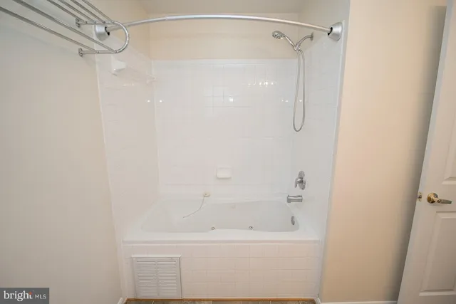 a bathroom with a shower and a bath tub