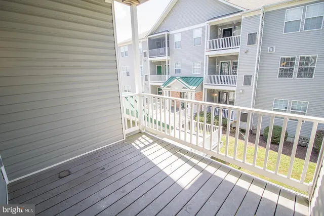 a view of a balcony with wooden floor
