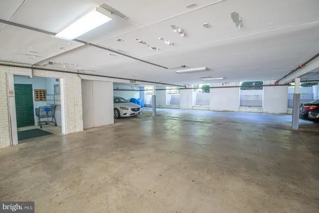 a view of a livingroom with an empty space and more windows