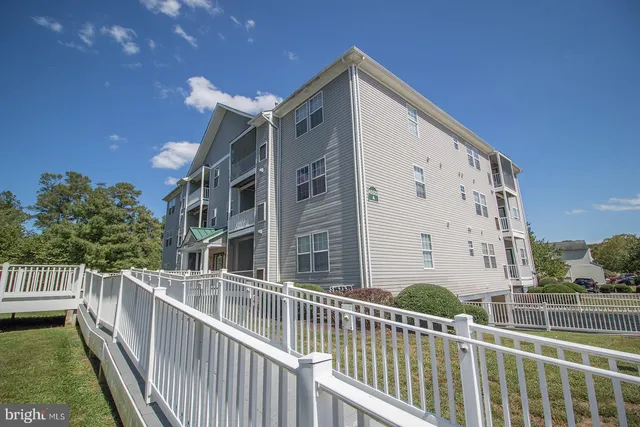 a view of a room with wooden floor table and chairs