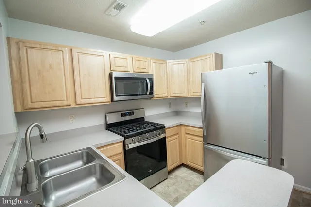 a kitchen with a refrigerator stove and microwave