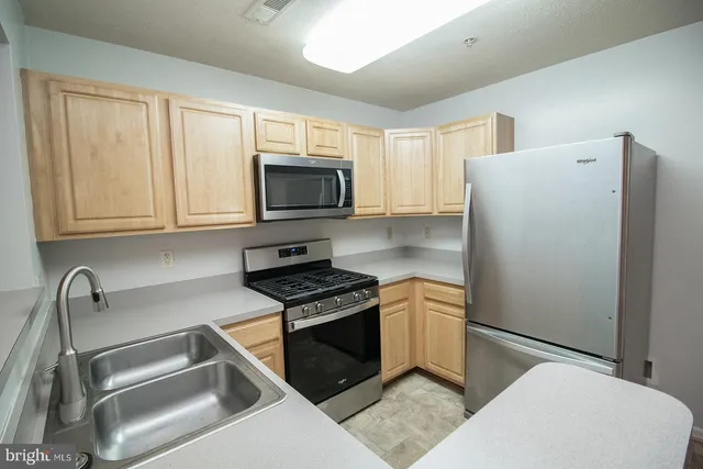 a kitchen with a refrigerator stove and microwave