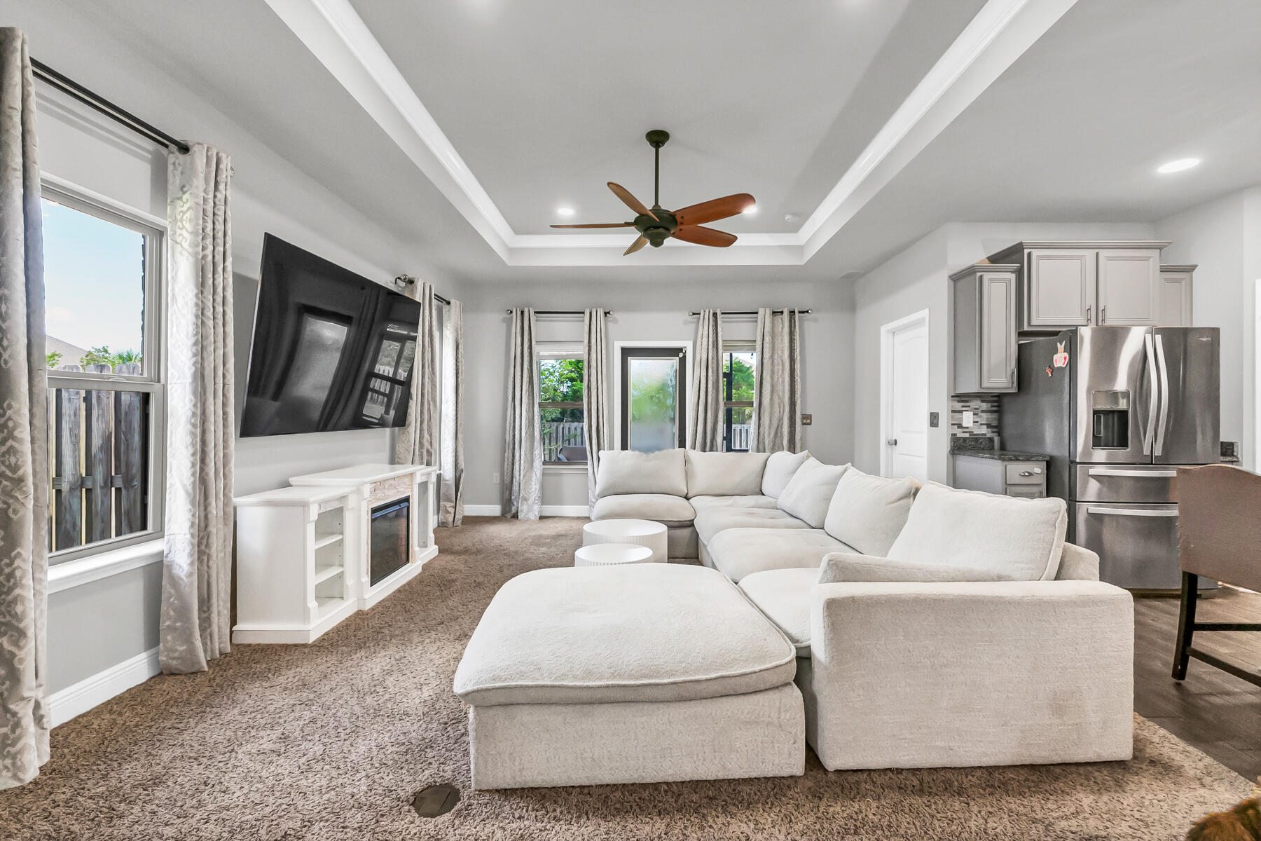 682 Teal Street Crestview, FL 32539 - Photo 22 of 34 a living room with furniture a flat screen tv and a fireplace