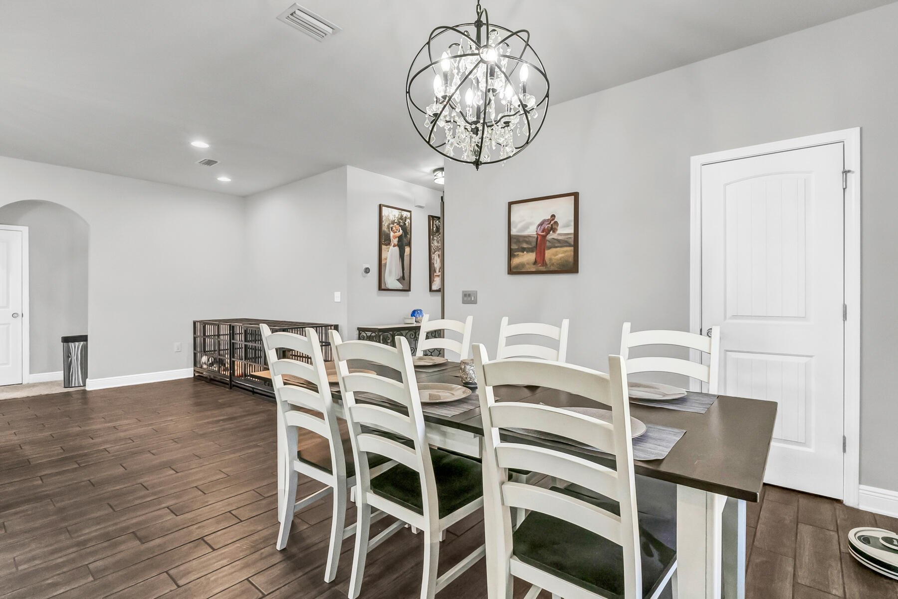 682 Teal Street Crestview, FL 32539 - Photo 24 of 34 a view of a dining room with furniture wooden floor and chandelier