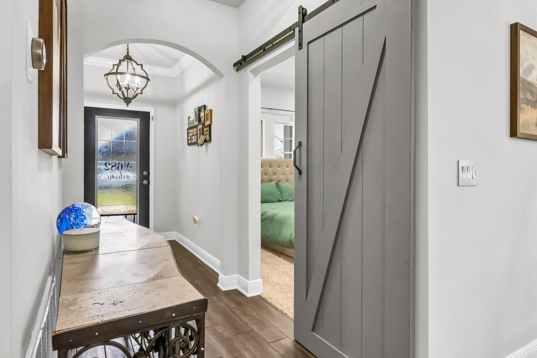 682 Teal Street Crestview, FL 32539 - Photo 26 of 34 a view of a hallway with wooden floor and entryway