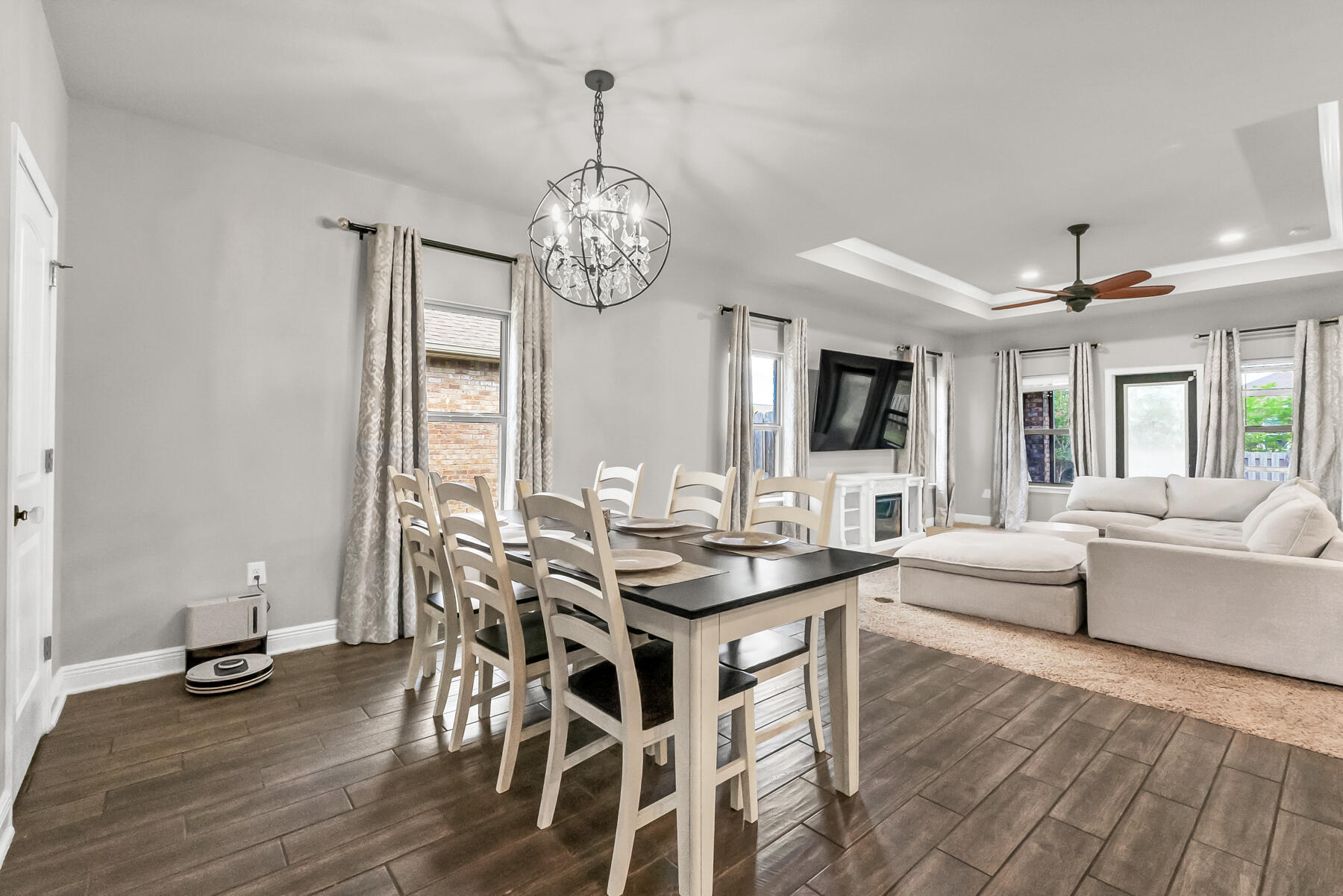 682 Teal Street Crestview, FL 32539 - Photo 3 of 34 a view of a dining room with furniture a chandelier and wooden floor