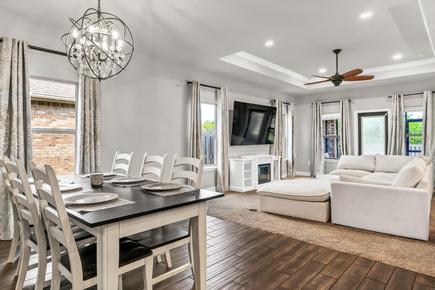 682 Teal Street Crestview, FL 32539 - Photo 4 of 34 a living room with furniture a chandelier and a flat screen tv