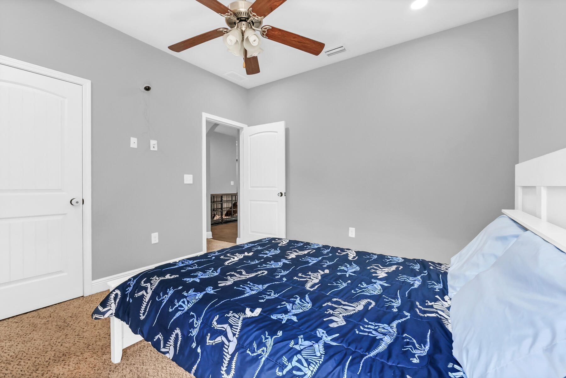 682 Teal Street Crestview, FL 32539 - Photo 9 of 34 a bedroom with a large bed and a chandelier