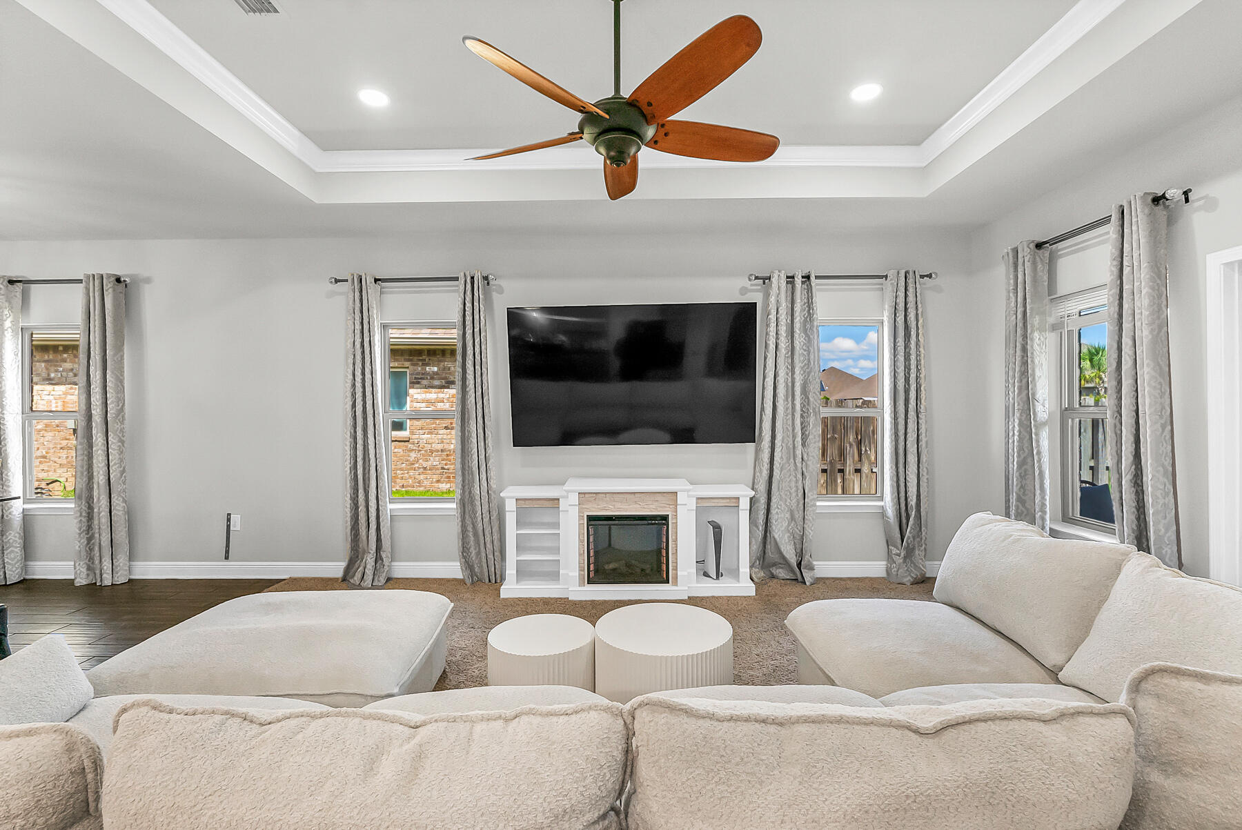 682 Teal Street Crestview, FL 32539 - Photo 10 of 34 a living room with furniture a flat screen tv and a fireplace