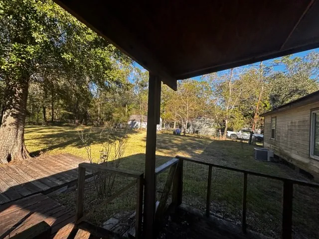 a view of swimming pool with outdoor seating and trees in the background