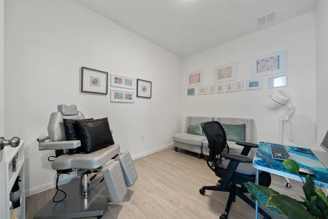 a view of a workspace with furniture and a window