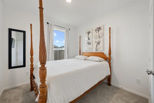 a bedroom with a bed and a mirror