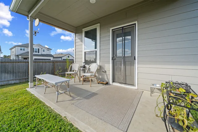 a building outdoor space with patio furniture and potted plants