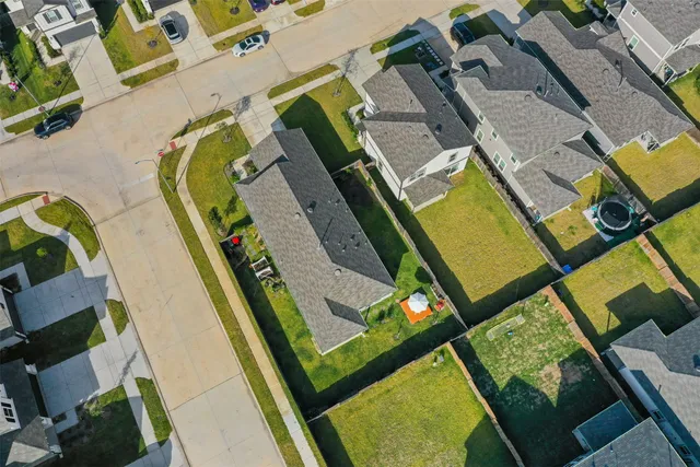 an aerial view of a swimming pool with outdoor seating