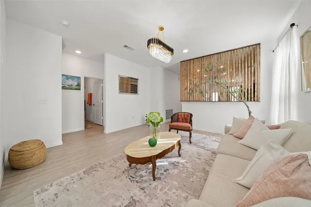 a living room with furniture a window and a table