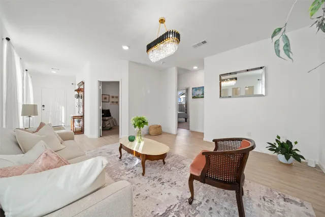 a living room with furniture and a potted plant