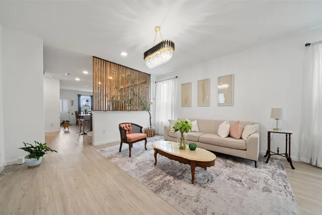 a living room with furniture and a wooden floor
