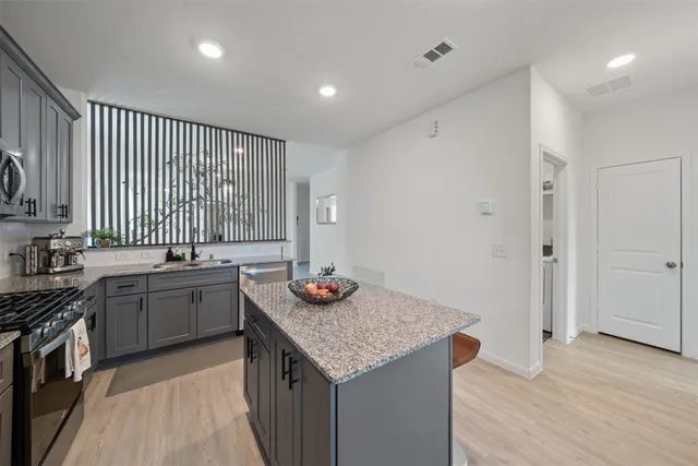 a kitchen with a sink stove and wooden cabinets