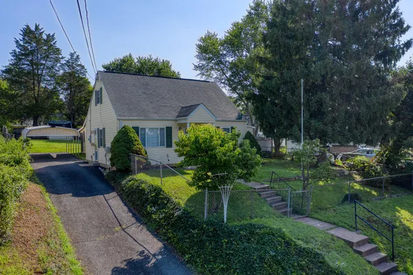 a view of house with outdoor space and garden