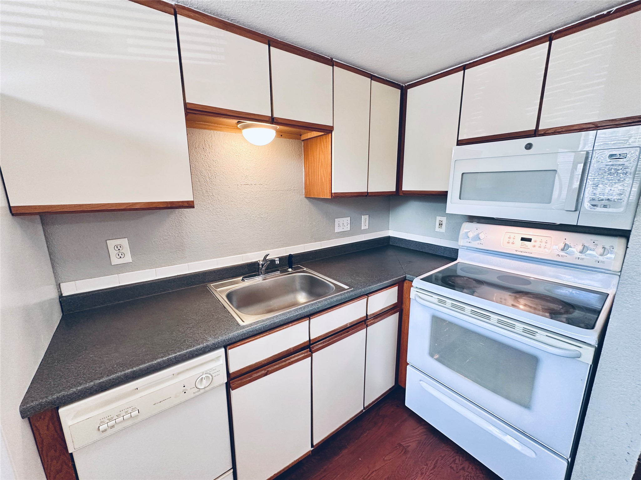 2500 Burleson Road, Unit 209 Austin, TX 78741 - Photo 10 of 24 Functional kitchen with ample cabinet space, a practical range, and integrated dishwasher.