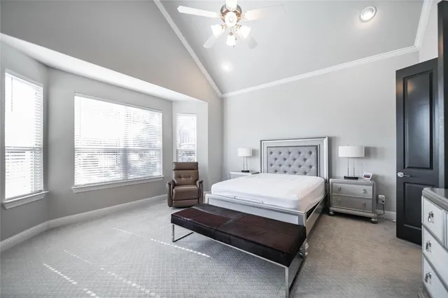 a spacious bedroom with a bed and a chandelier
