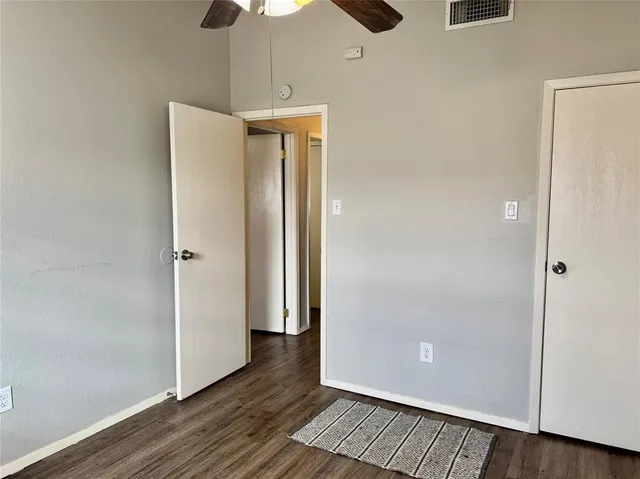 a view of a room with wooden floor