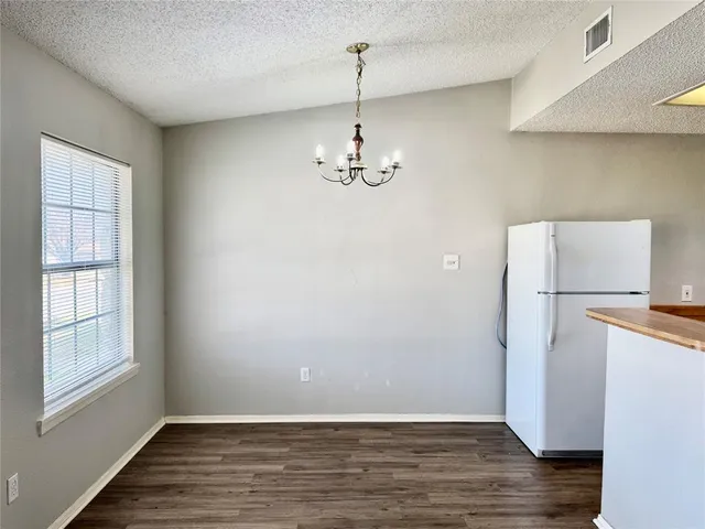 a view of a room with wooden floor and a window