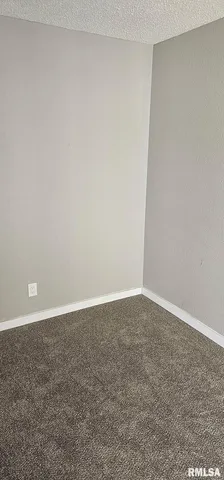 a view of a room with a wooden floor and a table