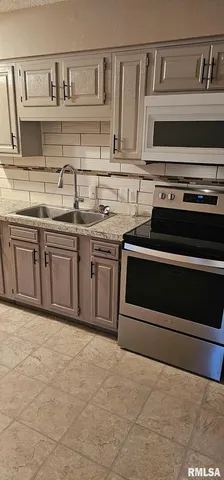 a kitchen with stainless steel appliances granite countertop a sink and stove top oven