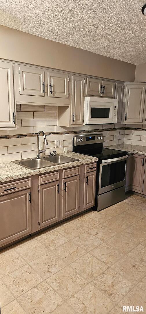 2515 North 3rd Street Clinton, IA 52732 - Photo 6 of 21 a kitchen with stainless steel appliances granite countertop a sink and stove top oven