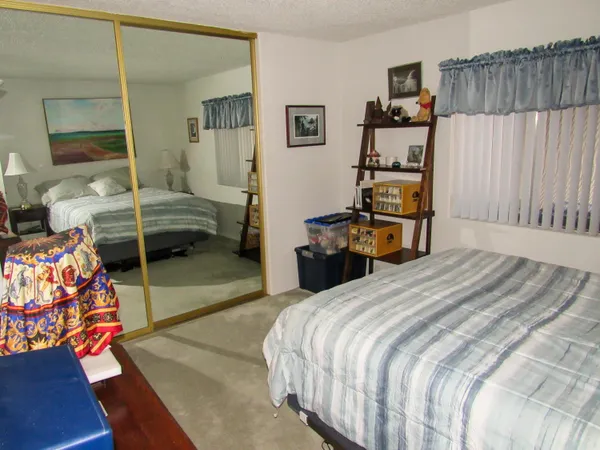 a bedroom with bed and window