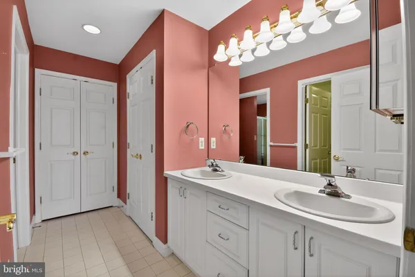 a bathroom with a double vanity sink and a mirror
